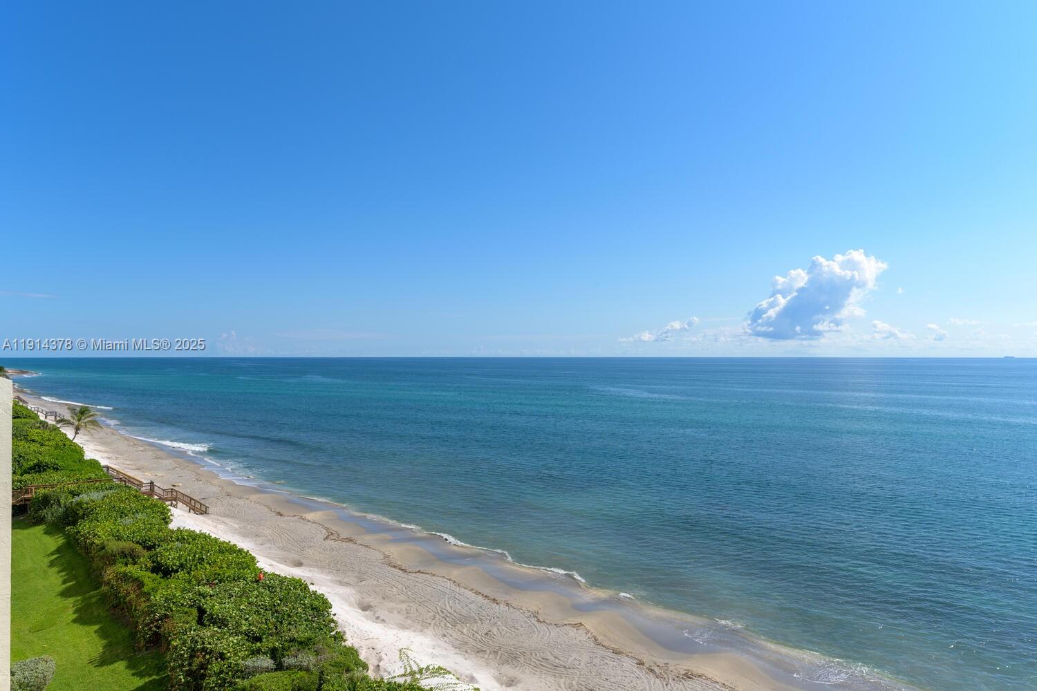 A high-angle view shows a sandy beach, green vegetation, and the ocean under a blue sky — 19670 Beach Rd, Tequesta FL 33469, TEQUESTA, FL