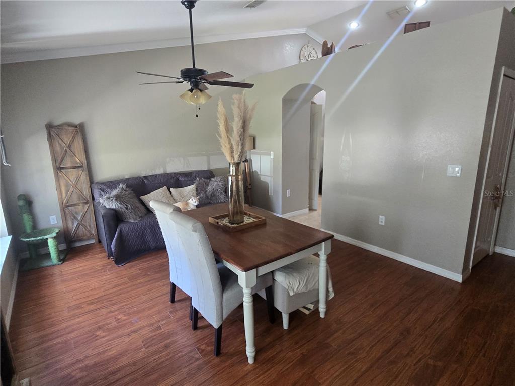 A room with wood flooring, a dark green chaise lounge, and a wooden folding screen — 15444 MOUNT SPARROW ROAD, WEEKI WACHEE, FL