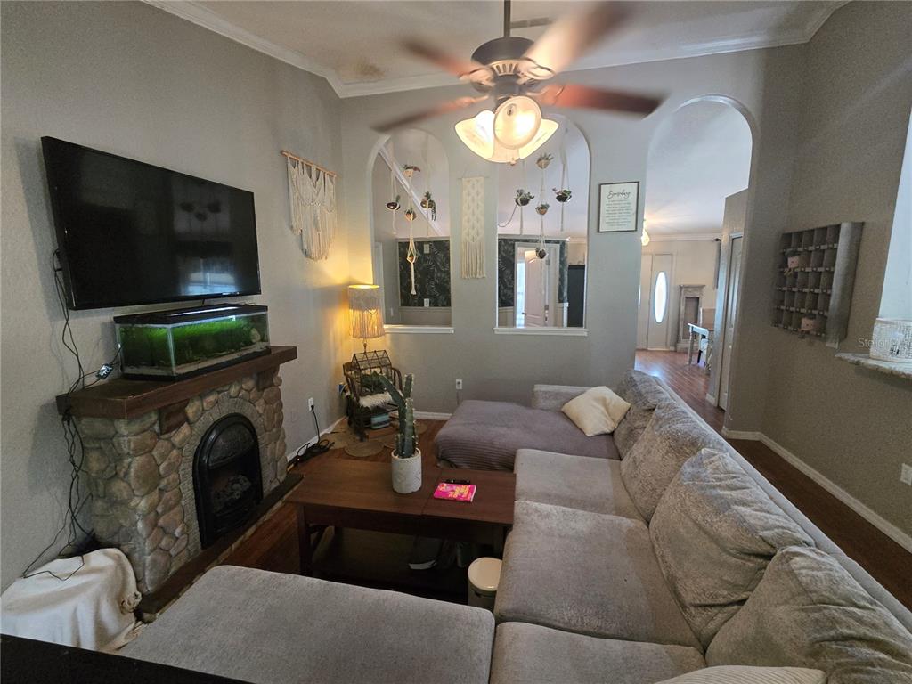 A dining room features wood flooring, a wooden table with chairs, and a ceiling fan — 15444 MOUNT SPARROW ROAD, WEEKI WACHEE, FL