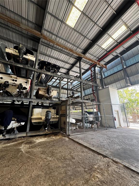 This indoor boat storage facility features multi-level metal racking systems for storing watercraft — 408 GULF OF MEXICO DRIVE UNIT 1332, LONGBOAT KEY, FL