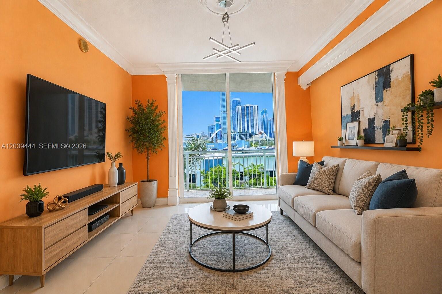A living room features bright orange walls, a beige sofa, and a balcony with city views — 275 NE 18th St # 504, Miami FL 33132, MIAMI, FL