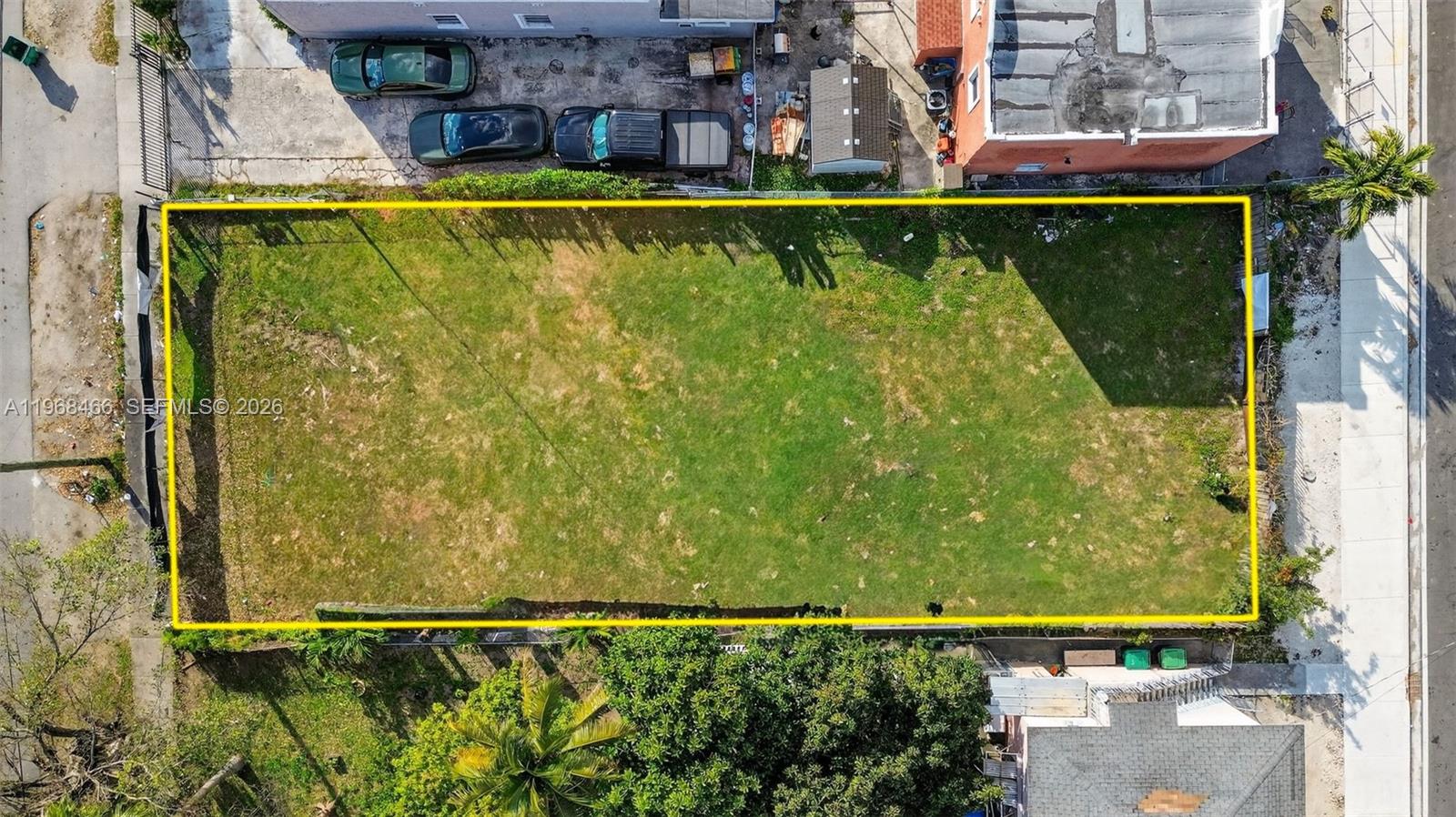 An aerial view shows a rectangular, grass-covered vacant lot outlined in yellow — 1753 NW 19th St, Miami FL 33125, MIAMI, FL