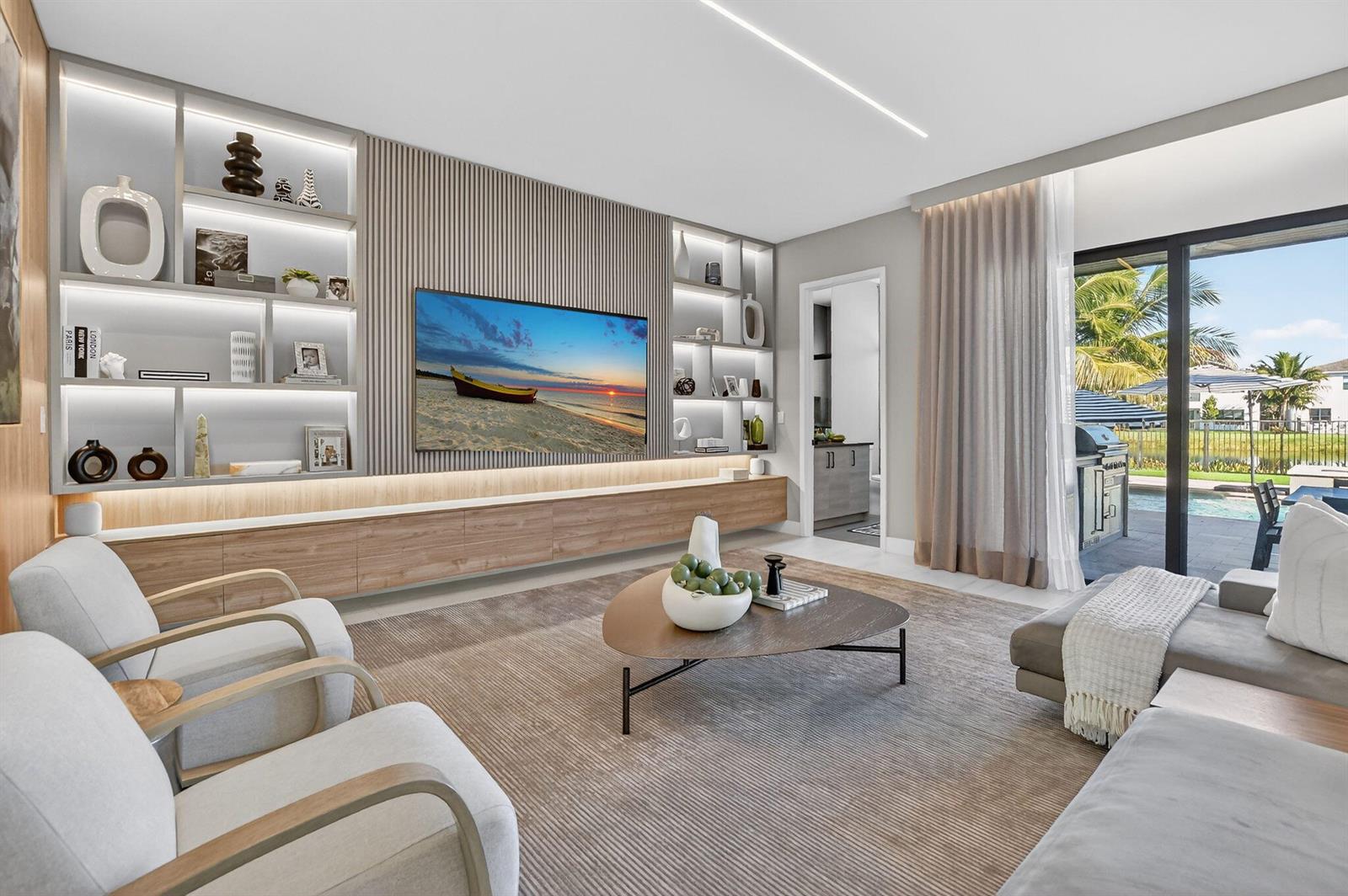 A modern living room features a slatted wood media wall, built-in shelving, and patio access — 17080 Teton River Road, Boca Raton FL 33496, BOCA RATON, FL