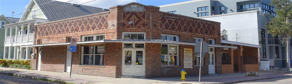 A corner brick commercial building with a decorative facade and a prominent 1929 date stone — 1618 E 5TH AVENUE, TAMPA, FL