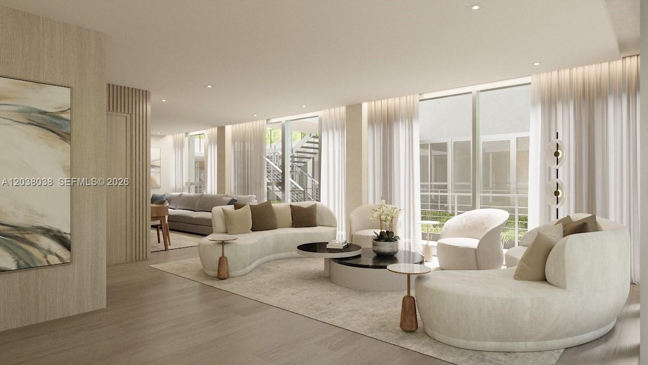 This is a rendering of a modern living room featuring curved sofas and floor-to-ceiling windows — 250 Collins Ave # 305, Miami Beach FL 33139, MIAMI BEACH, FL