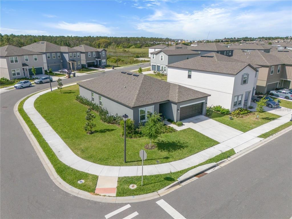 An aerial view shows a gray single-story house on a corner lot with a garage — 2375 LANCASHIRE STREET, DAVENPORT, FL