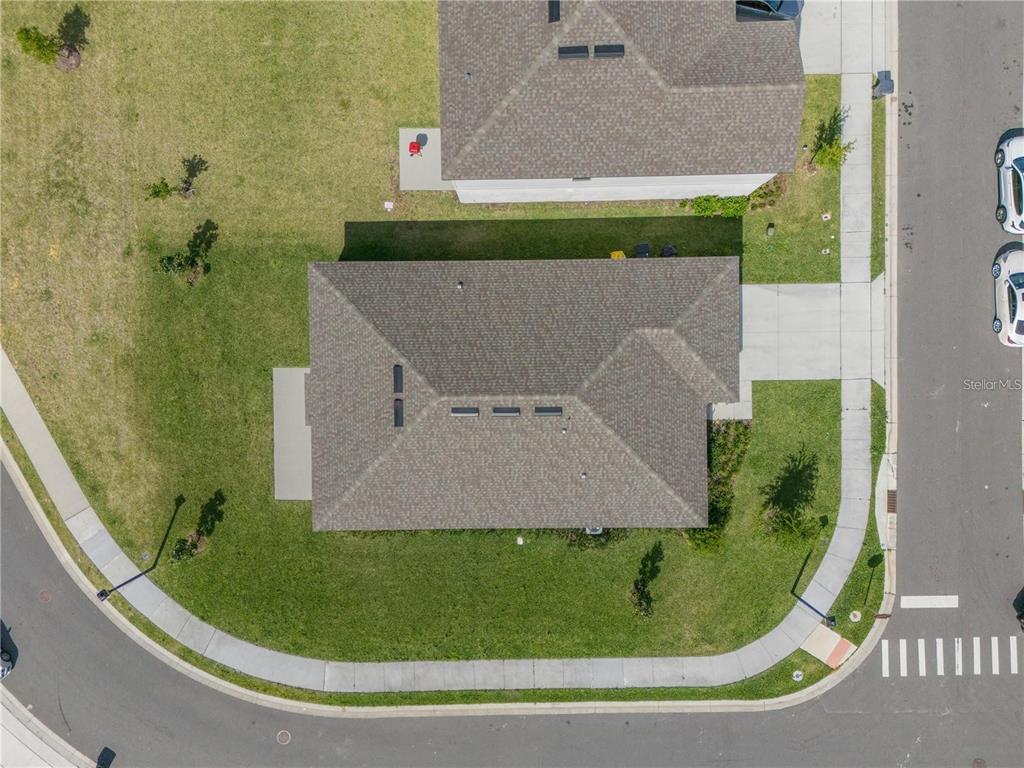 An aerial view shows a residential house with a shingled roof and a concrete driveway — 2375 LANCASHIRE STREET, DAVENPORT, FL