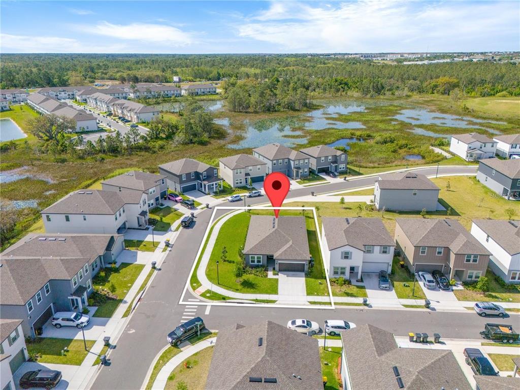 An aerial view shows a single-story house with a corner lot in a suburban neighborhood — 2375 LANCASHIRE STREET, DAVENPORT, FL
