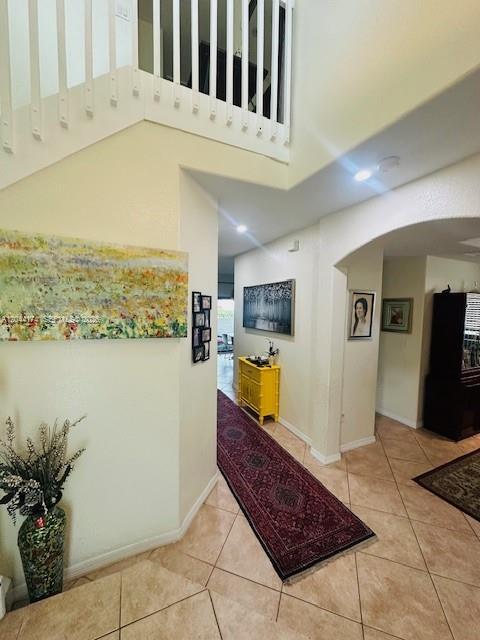 An interior view shows a tiled foyer with a staircase, a hallway, and a runner rug — 4318 NW 113th Pl, Doral FL 33178, DORAL, FL