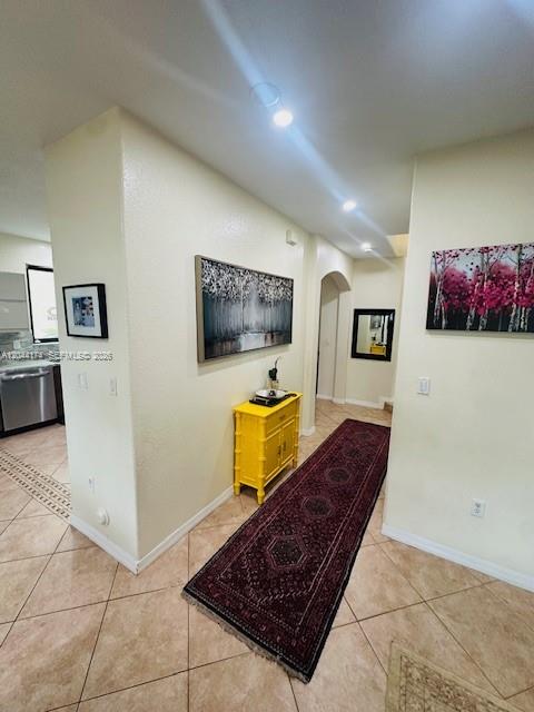A hallway features a yellow cabinet, a long patterned rug, and wall art on tile floors — 4318 NW 113th Pl, Doral FL 33178, DORAL, FL