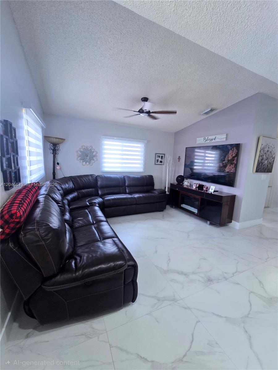 A living room features a large brown sectional sofa, a television, and white tile flooring — 2727 W 70th St, Hialeah FL 33016, HIALEAH, FL