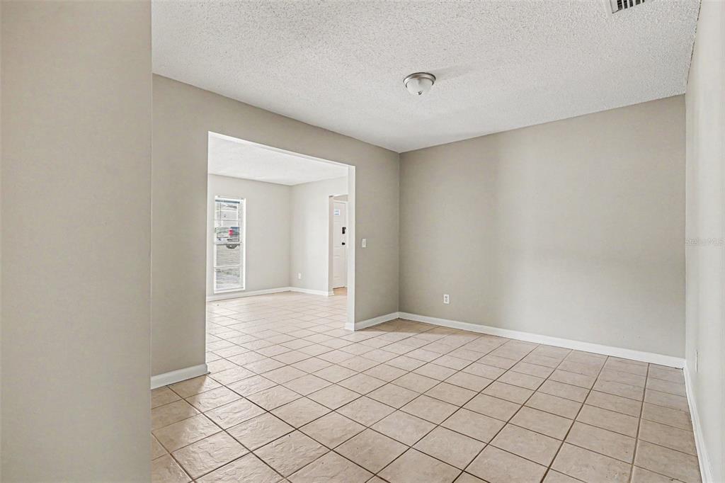 An interior view shows a tiled room leading into another space through a wide doorway — 1534 HALLAM COURT S, LAKELAND, FL