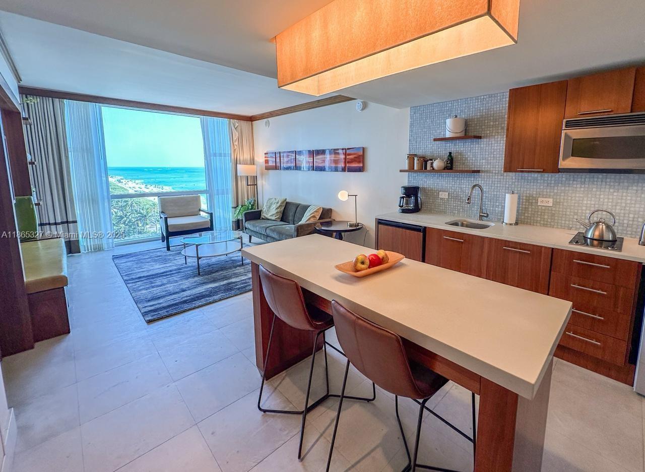 A studio apartment features a kitchenette, a dining island, and a living area with ocean views — 6801 Collins Ave # 815, Miami Beach FL 33141, MIAMI BEACH, FL