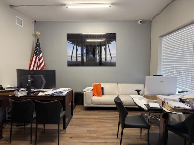 An office space features a desk, a white sofa, and a large pier photograph on the wall — 9511 N NEBRASKA AVENUE, TAMPA, FL