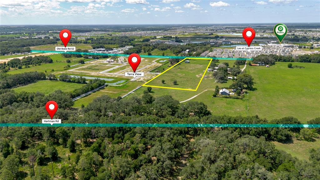 This aerial map shows a vacant plot of land outlined in yellow near residential developments — 31641 COUNTY ROAD 52, SAN ANTONIO, FL