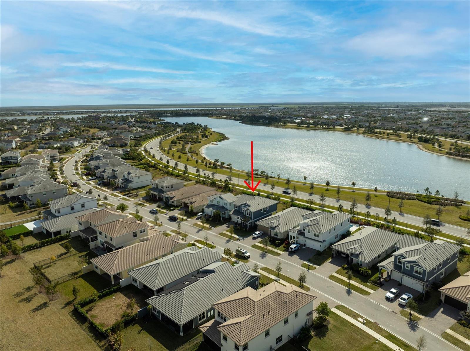 An aerial view shows a suburban neighborhood with a house marked by a red arrow — 19552 Broad Shore Walk, Loxahatchee FL 33470, LOXAHATCHEE, FL