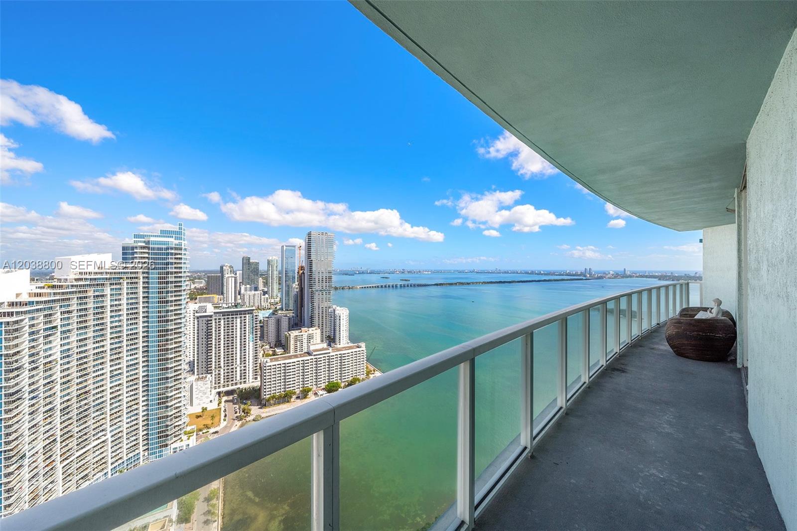 A high-rise balcony overlooks a city skyline and a large body of water — 1900 N Bayshore Dr # 4504, Miami FL 33132, MIAMI, FL