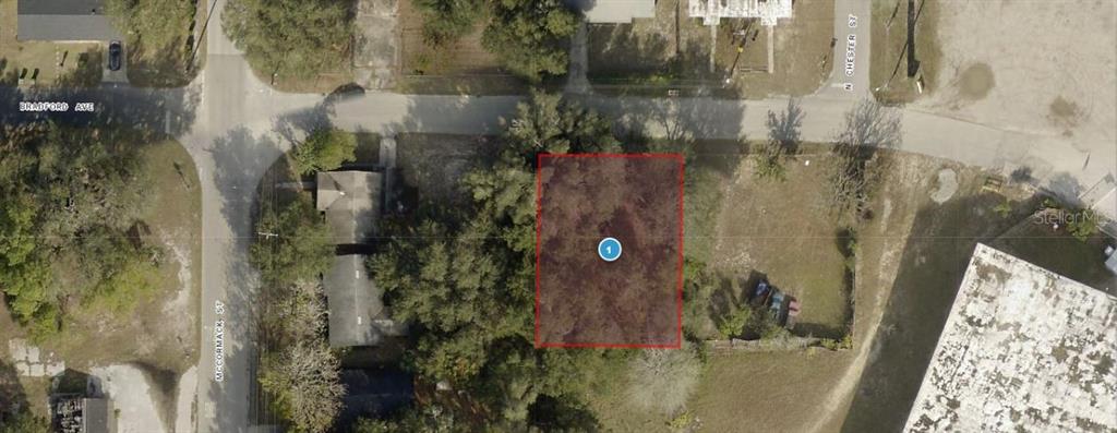This is an aerial map view of a rectangular vacant lot highlighted in red — 1903 BRADFORD AVENUE, LEESBURG, FL