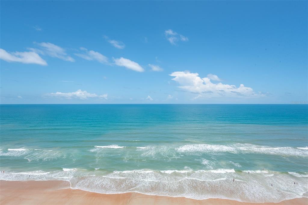 An elevated view of a sandy beach and the ocean under a blue sky — 2545 S ATLANTIC AVENUE UNIT 1804, DAYTONA BEACH SHORES, FL