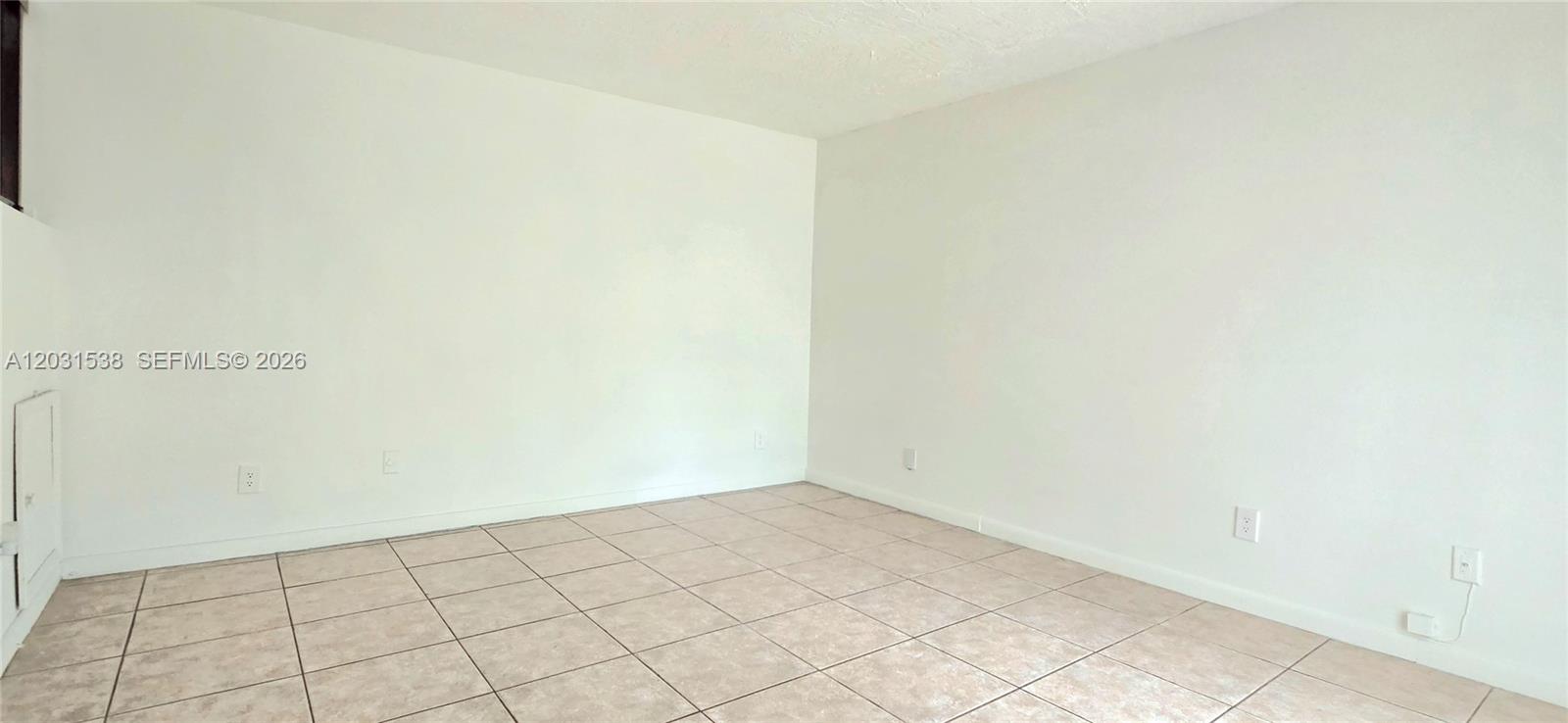An empty room features white walls and light-colored square floor tiles — 608 Commodore Dr, Plantation FL 33325, PLANTATION, FL