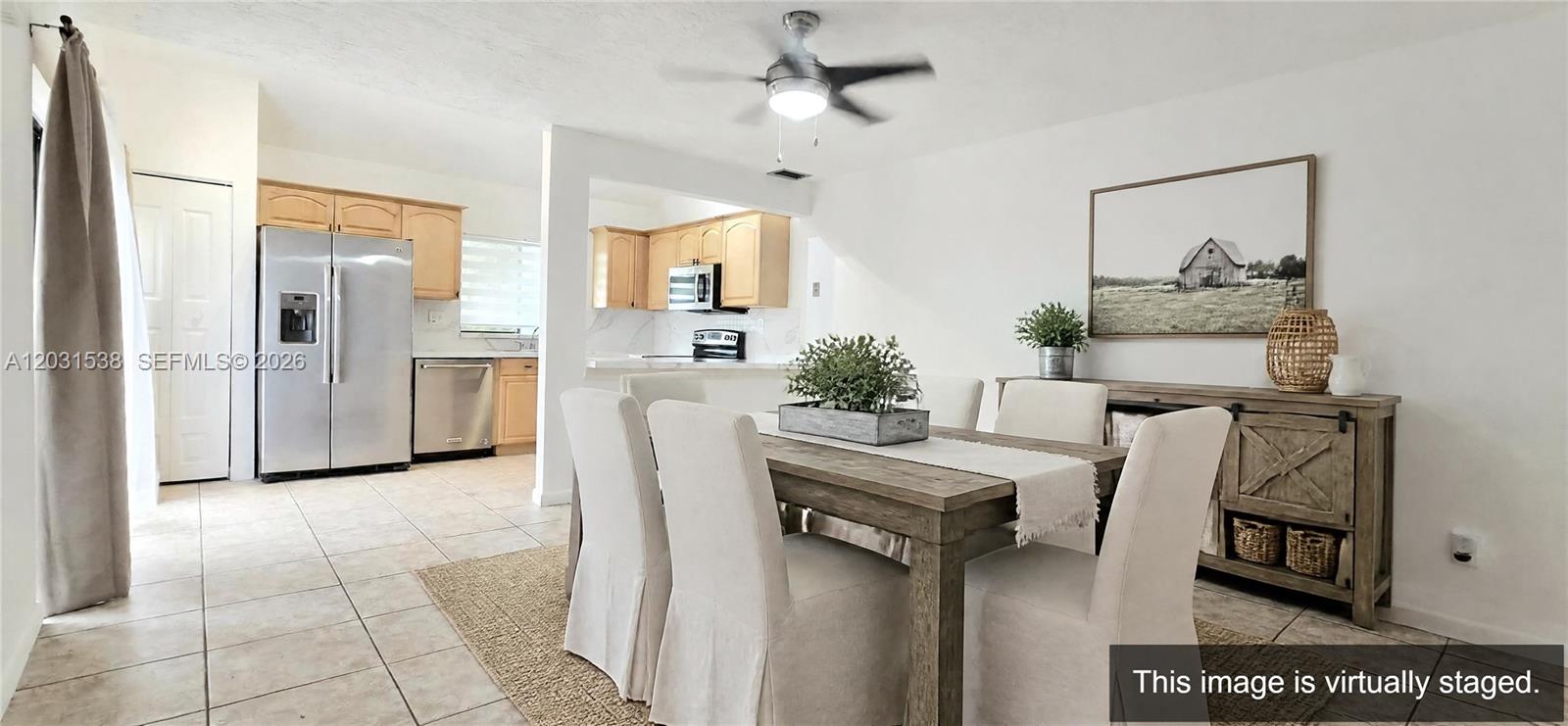 This virtually staged dining room features a wooden table, upholstered chairs, and a sideboard — 608 Commodore Dr, Plantation FL 33325, PLANTATION, FL