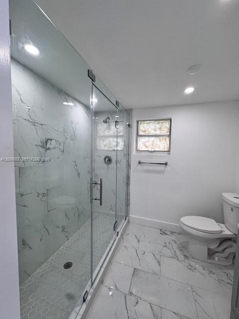 A bathroom features a glass-enclosed walk-in shower with marble-patterned tile and a white toilet — 4783 NW Flagler Ter, Miami FL 33126, MIAMI, FL