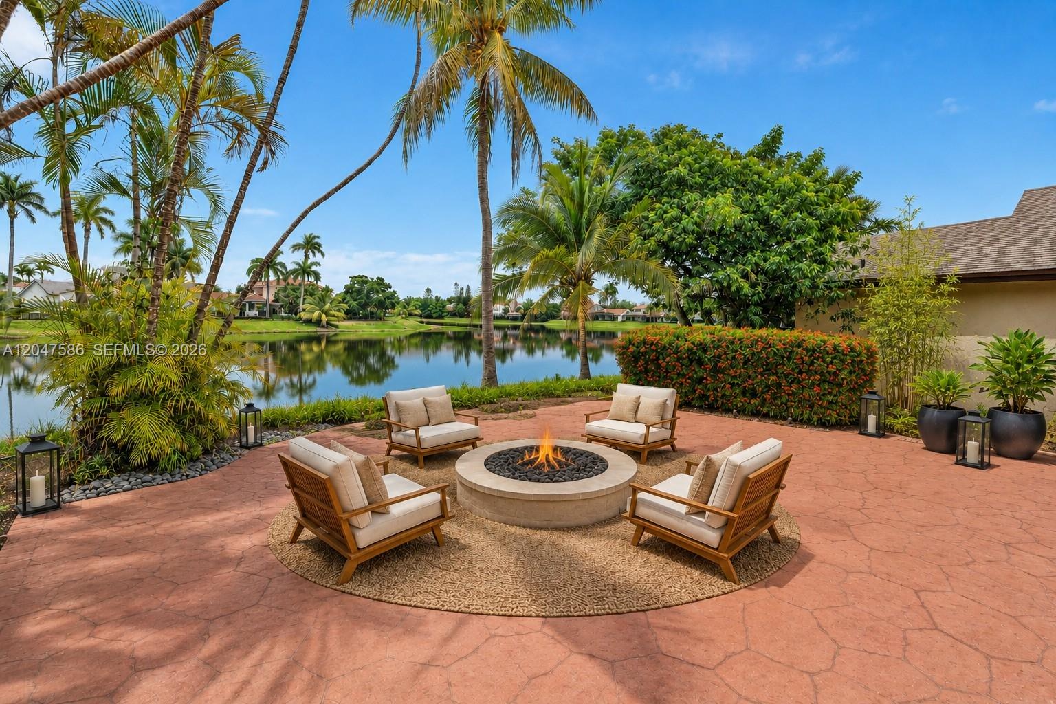 A patio features a circular fire pit surrounded by four chairs on a textured rug — 4224 SW 148th Pl, Miami FL 33185, MIAMI, FL
