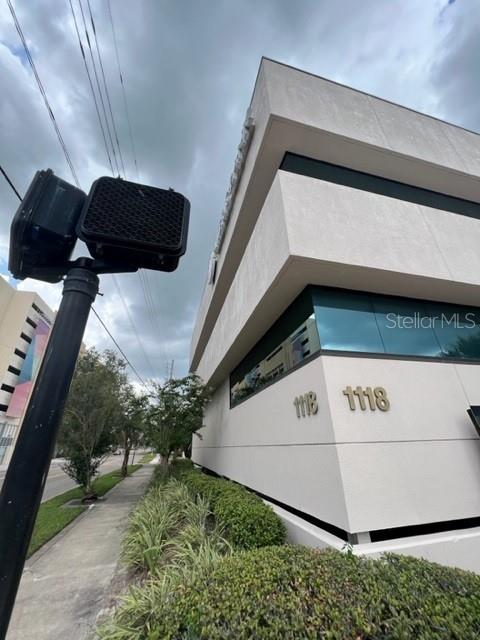 A low-angle view of a modern commercial building exterior with the address 1118 displayed — 1118 S ORANGE AVENUE UNIT 104, ORLANDO, FL