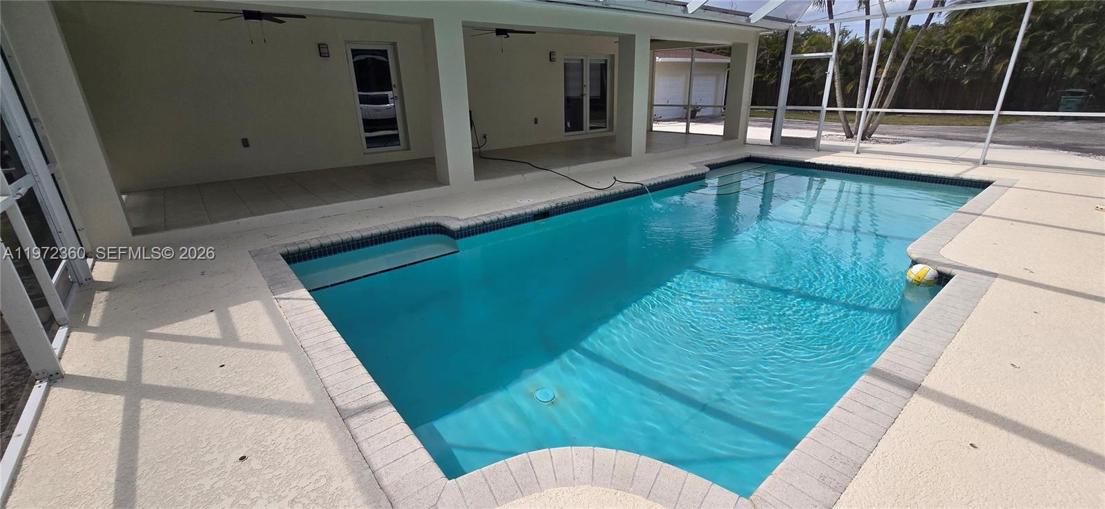 A screened-in swimming pool sits on a patio adjacent to a covered porch — 6500 SW 82nd Ave, Miami FL 33143, MIAMI, FL