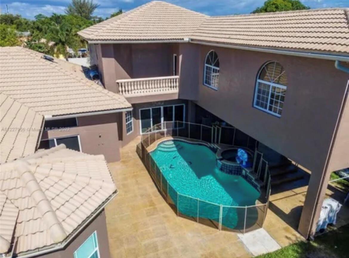 An aerial view of a two-story house with a swimming pool and a safety fence — 423 NE 3rd Street, Pompano Beach FL 33060, POMPANO BEACH, FL