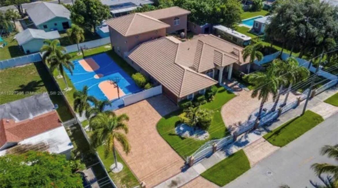 An aerial view of a house with a blue basketball court and a paved driveway — 423 NE 3rd Street, Pompano Beach FL 33060, POMPANO BEACH, FL