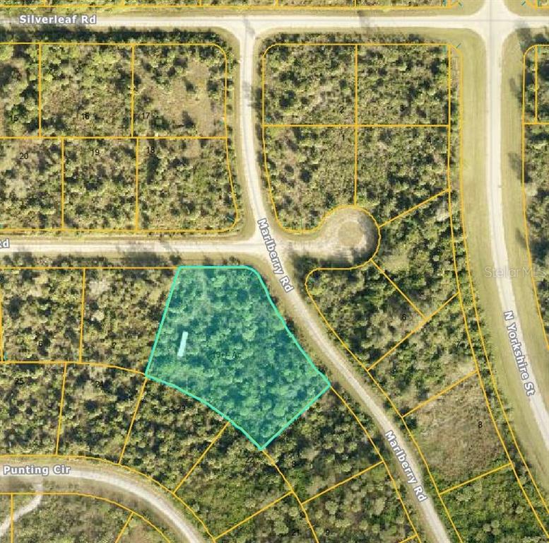 This is an aerial map showing a highlighted vacant lot bordered by roads — MARLBERRY ROAD, NORTH PORT, FL