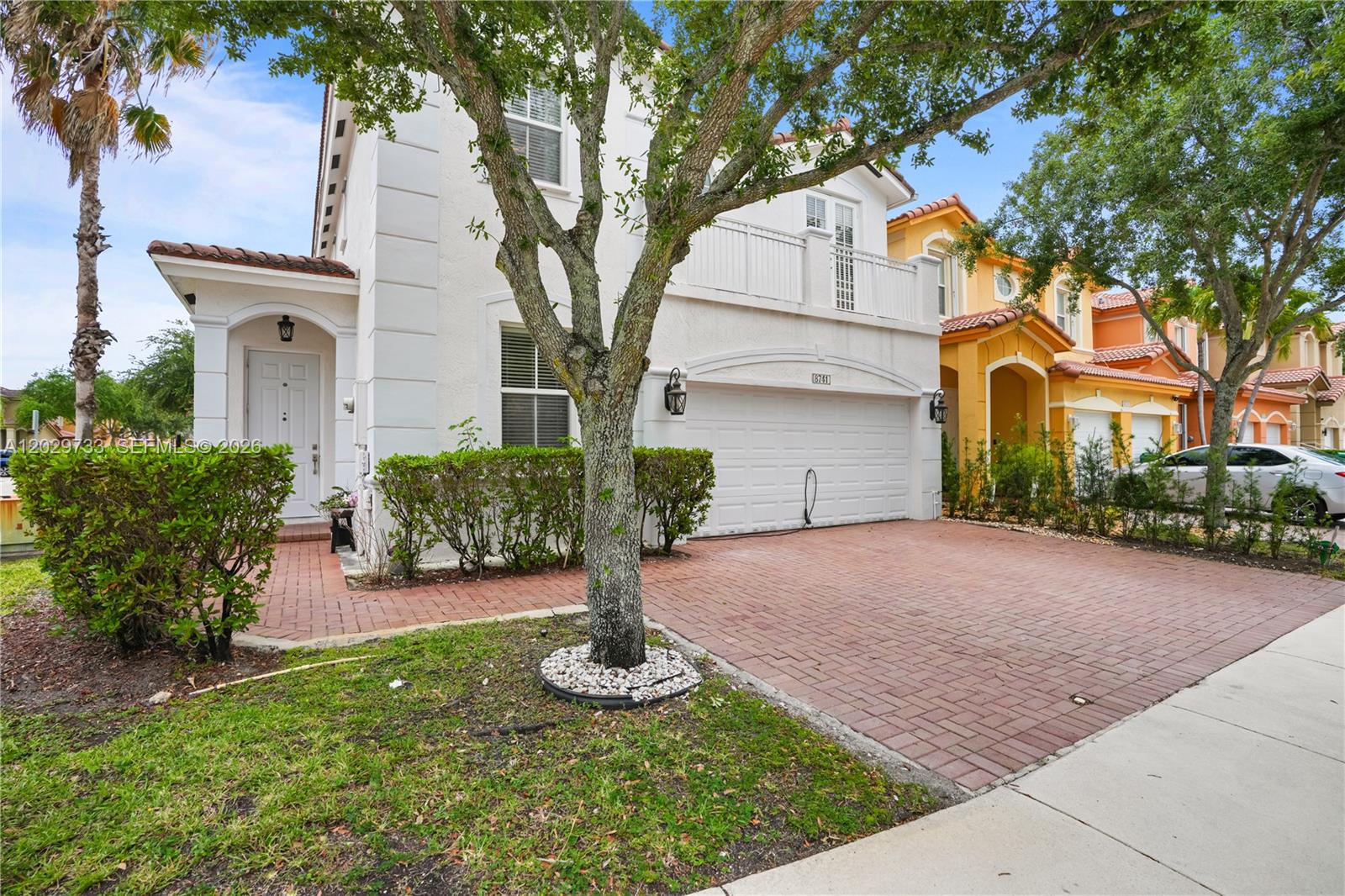 A two-story white house with a brick driveway and a front-yard tree — 8741 NW 110th Ave, Doral FL 33178, DORAL, FL