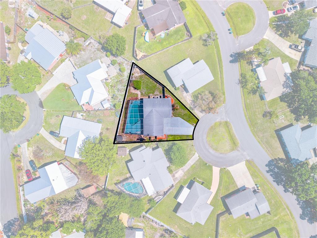 This aerial view shows a residential property with a pool and screened enclosure — 683 JOHN HANCOCK LANE, WEST MELBOURNE, FL