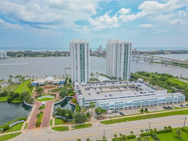 An aerial view shows two high-rise residential towers connected to a multi-level parking garage — 231 RIVERSIDE DRIVE UNIT 709-1, DAYTONA BEACH, FL