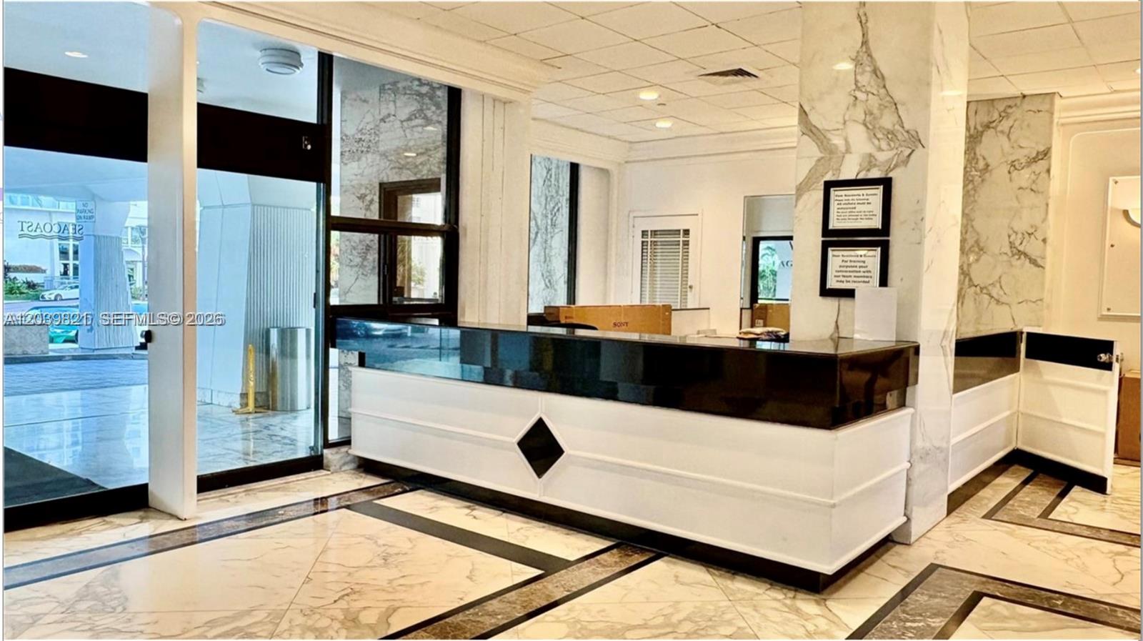 A living room features a beige sectional sofa, a mustard yellow chair, and a round table — 5700 Collins Ave # 3N, Miami Beach FL 33140, MIAMI BEACH, FL