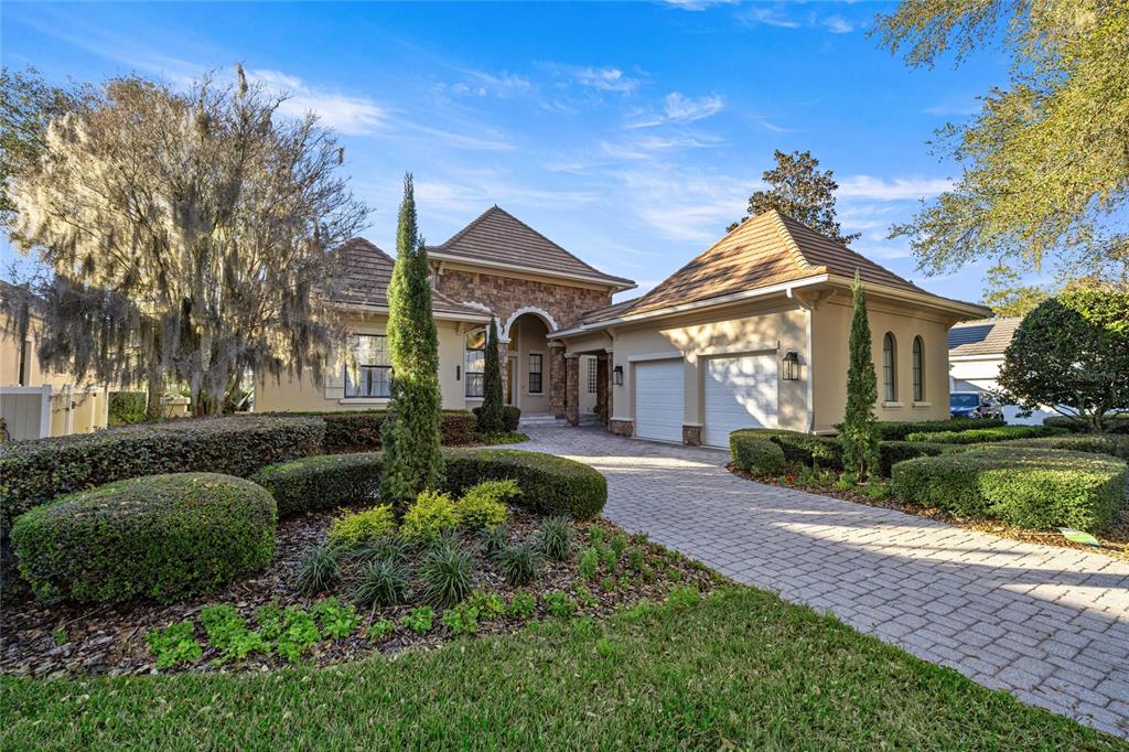 A single-story house with a stone facade, a tiled roof, and a paved driveway — 2730 NW 80TH AVENUE, OCALA, FL