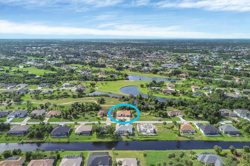 An aerial view shows a residential neighborhood with a blue circle highlighting a single-family home — 102 MARKER ROAD, ROTONDA WEST, FL