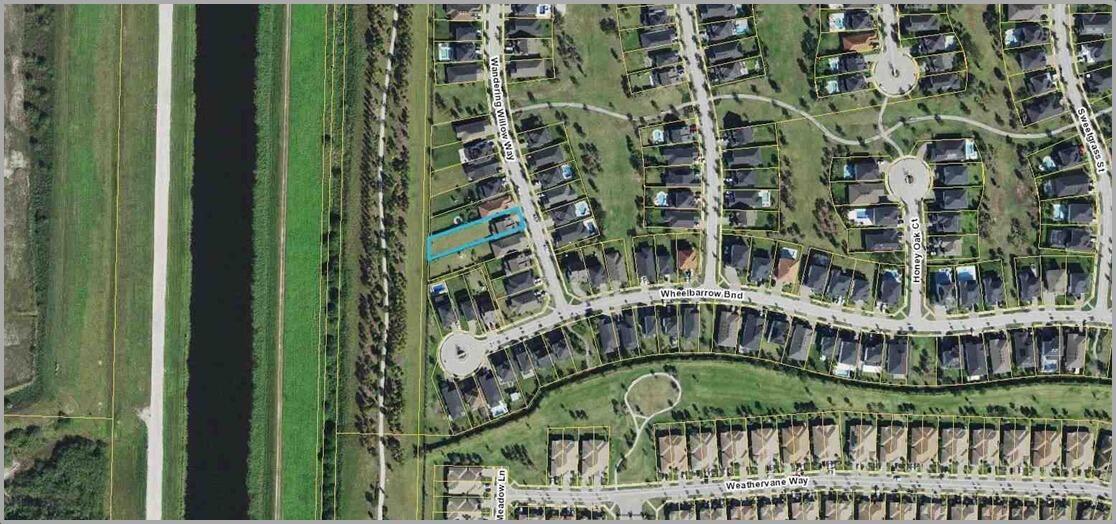 This is an aerial map showing a residential property highlighted in blue within a neighborhood — 857 Wandering Willow Way, FL 33470, FL