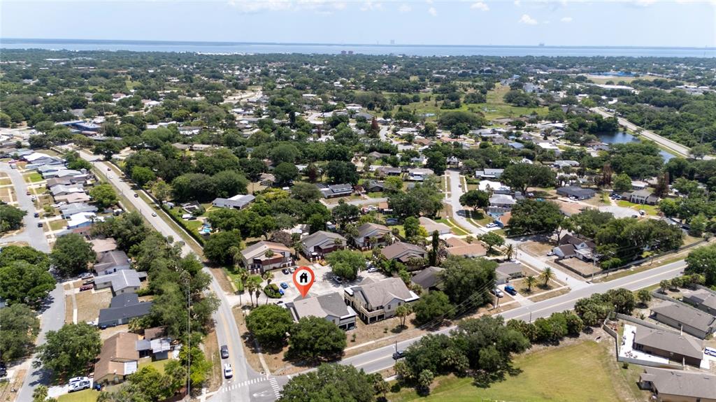 An aerial view shows a residential neighborhood with a marked multi-unit building and surrounding homes — 2613 S PARK AVENUE, TITUSVILLE, FL