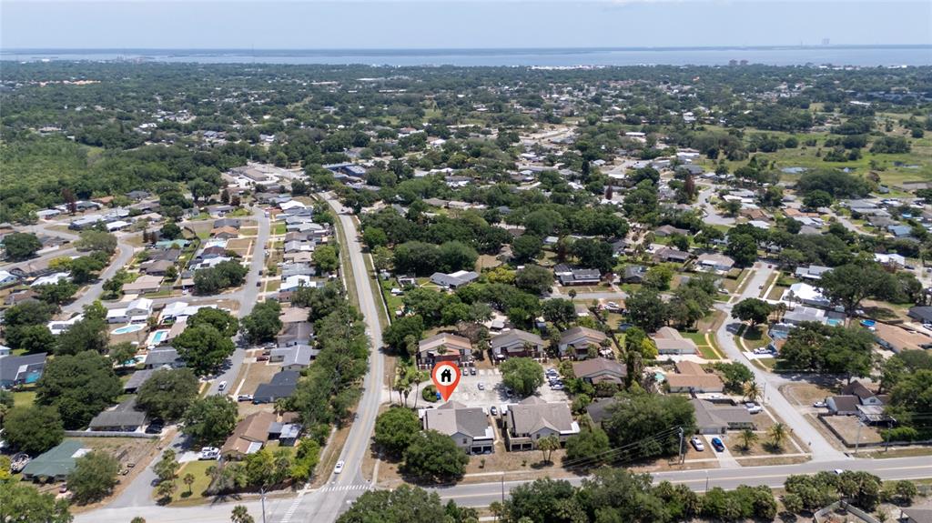 An aerial view shows a residential neighborhood with a highlighted multi-unit building near a road — 2613 S PARK AVENUE, TITUSVILLE, FL