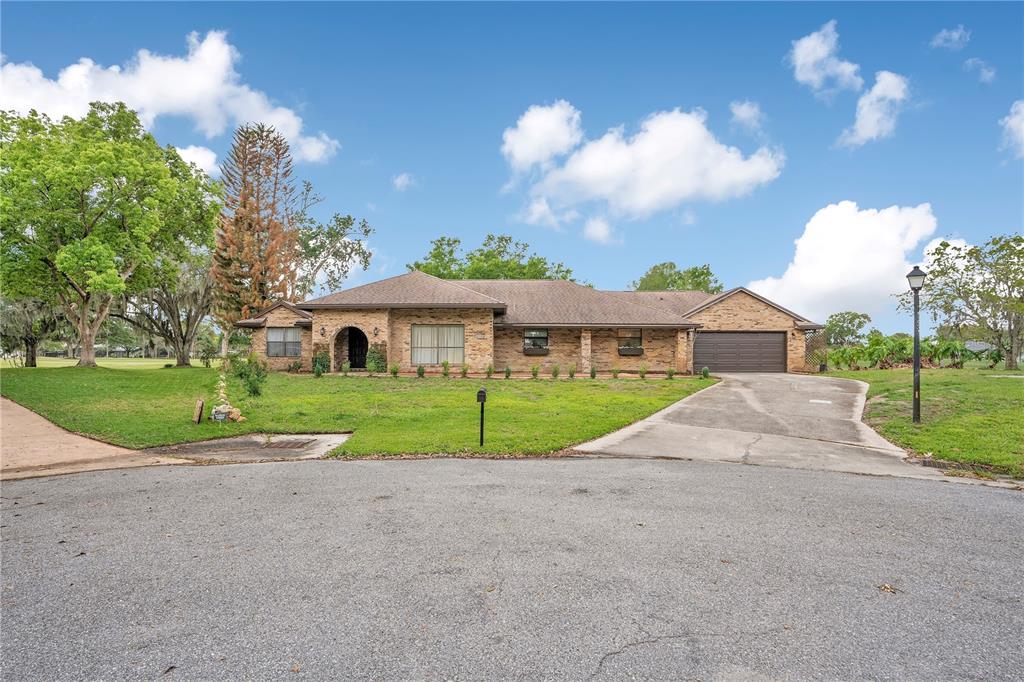 A single-story brick house with a brown roof and a two-car garage — 2724 ARDON AVENUE, ORLANDO, FL