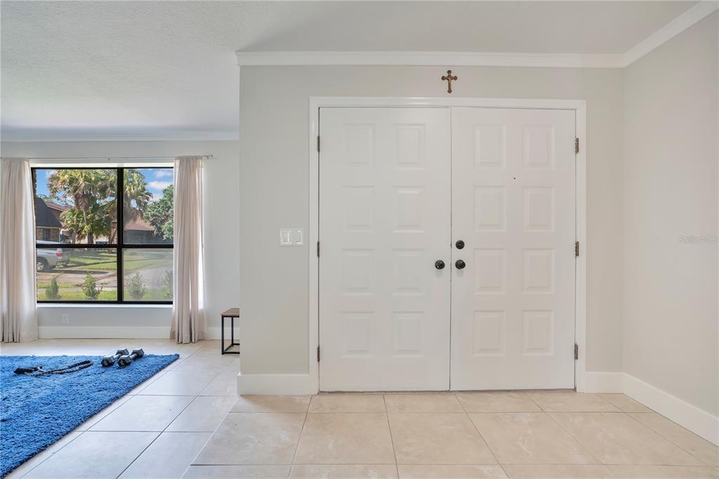 A single-story brick house with a brown roof and attached garage sits on a lawn — 2724 ARDON AVENUE, ORLANDO, FL