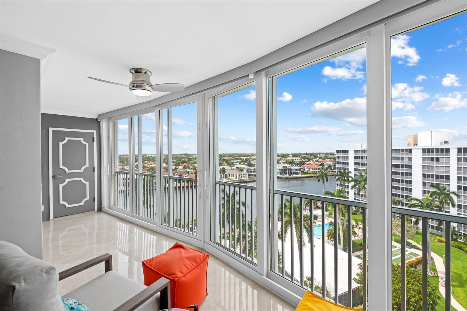 A sunroom with tile floors, a ceiling fan, and large windows overlooking a waterfront view — 3300 S Ocean Boulevard # 1020, Highland Beach FL 33487, HIGHLAND BEACH, FL