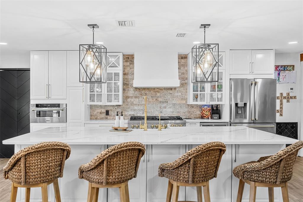 A house exterior features a covered porch with wooden beams and a paver patio — 17224 OLD COUNTRY LANE, WINTER GARDEN, FL