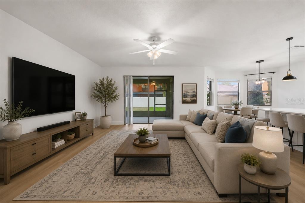 A living room features a large sectional sofa, a wooden coffee table, and a television — 1908 ABBEY RIDGE DRIVE, DOVER, FL