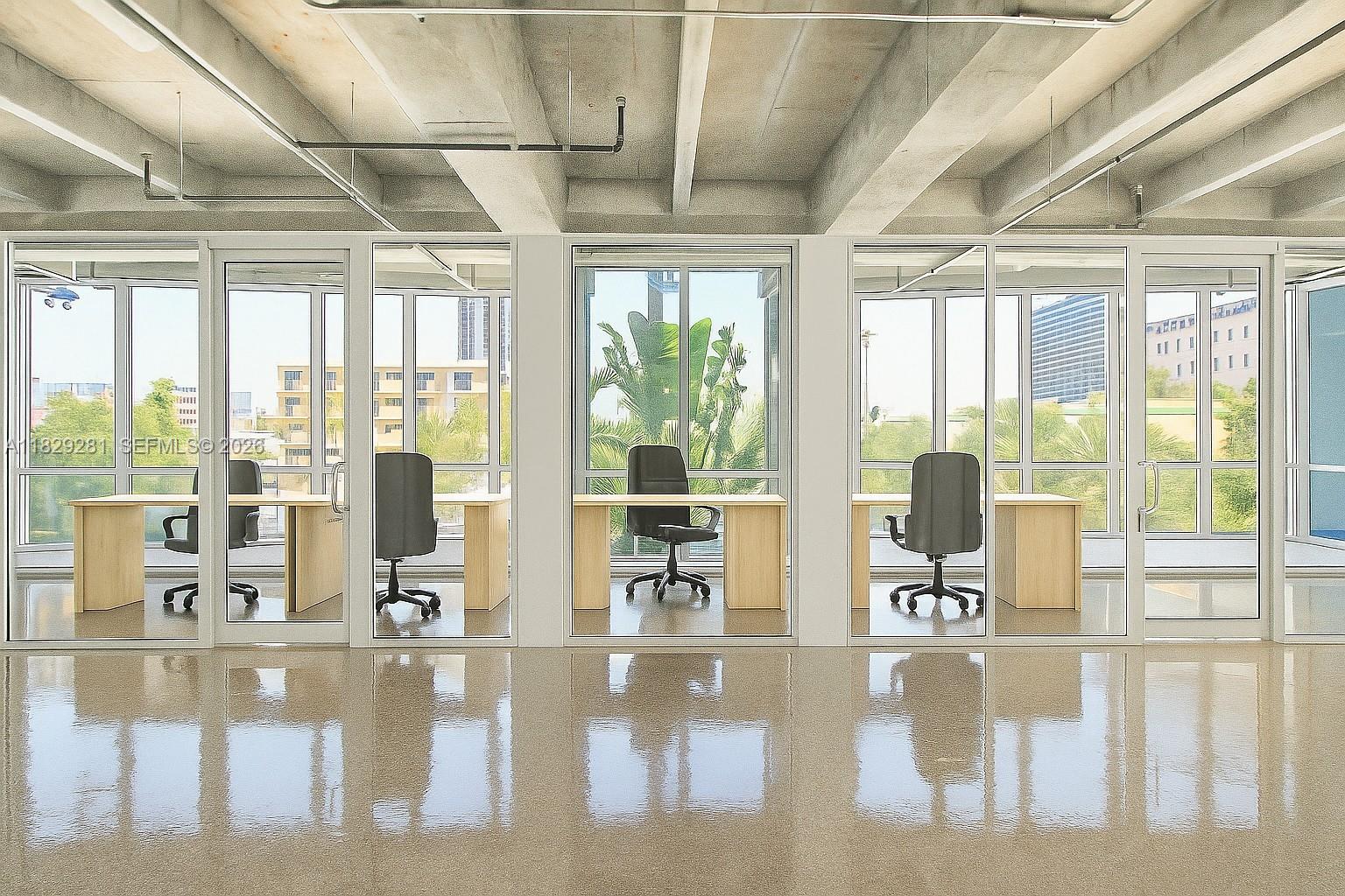 A row of glass-walled offices features light wood desks, black chairs, and polished concrete floors — 6936 Collins Ave, Miami Beach FL 33141, MIAMI BEACH, FL