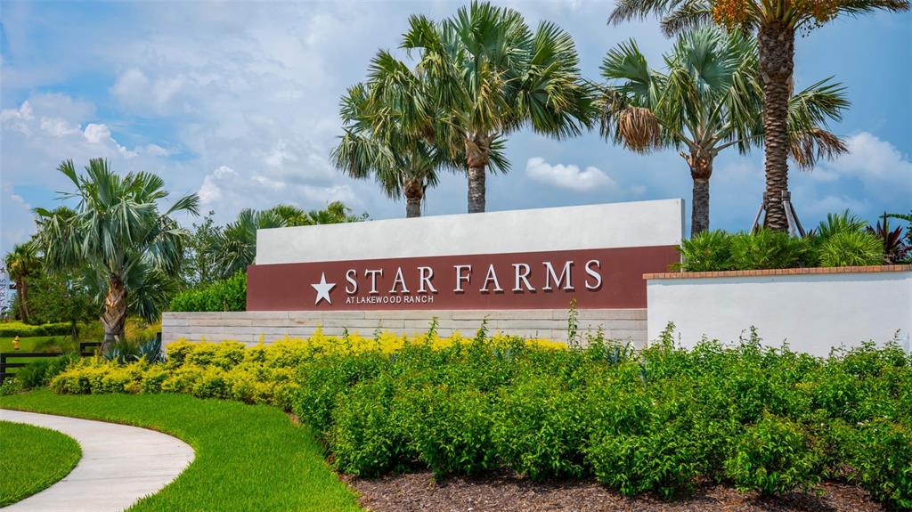 A sign for Star Farms at Lakewood Ranch stands in a landscaped garden with palm trees — 18614 WITHERS PLACE, BRADENTON, FL