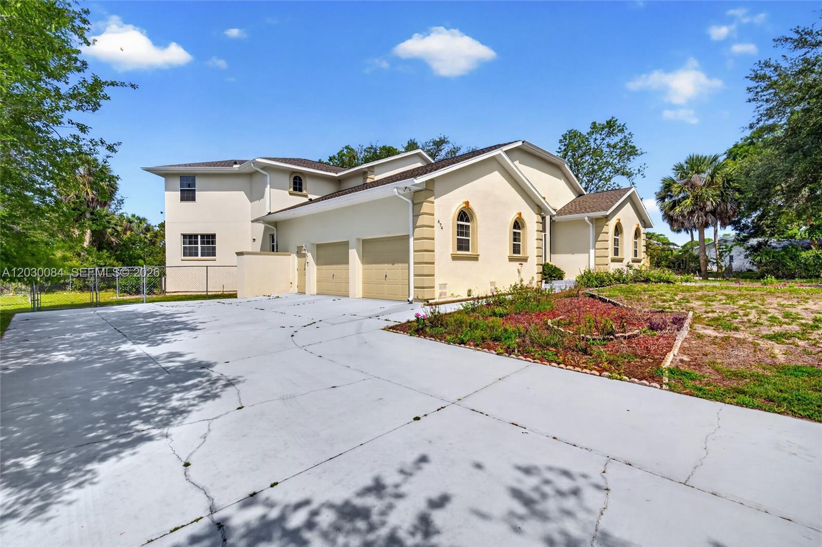 A two-story stucco house with a two-car garage and a large concrete driveway — 474 N Afterglow Circle, Crystal River FL 34429, CRYSTAL RIVER, FL