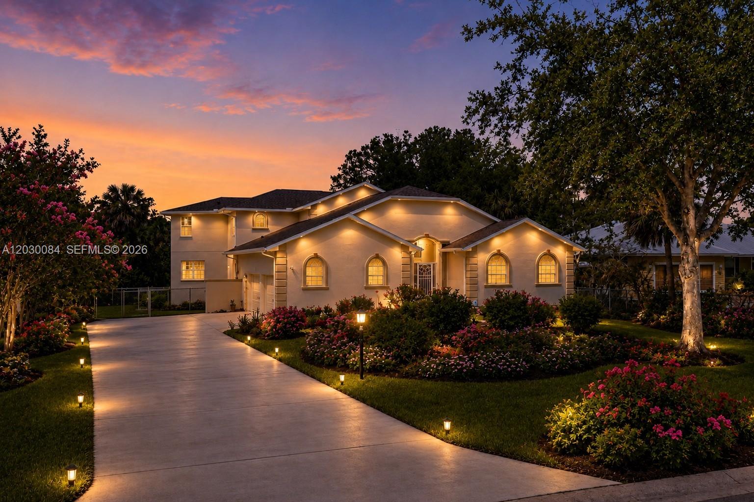 A two-story house with a concrete driveway and landscaped yard at sunset — 474 N Afterglow Circle, Crystal River FL 34429, CRYSTAL RIVER, FL